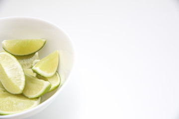 Close up of fresh sliced limes in a white ball