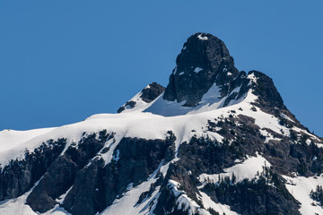 mountain peak like a laying down man under the blue sky