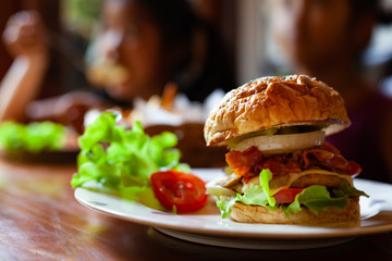 Homemade hamburger with fresh vegetables on dish in the restaurant