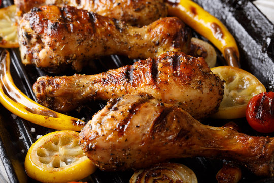 Grilled Chicken Drumstick Legs With Vegetables In The Grill Pan Close-up. Horizontal