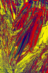 Abstract micrograph of ascorbic acid crystals in brilliant arrays.