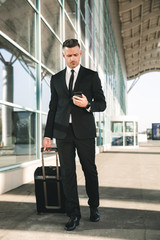 Confident businessman dressed in suit walking