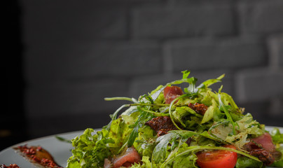 Vegetable salad on a plate on a glass background