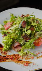 Vegetable salad on a plate on a glass background
