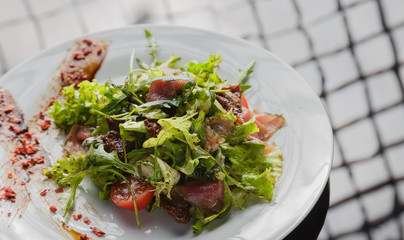 Vegetable salad on a plate on a glass background