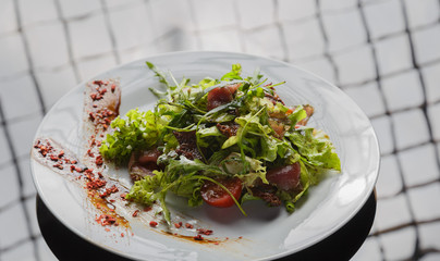 Vegetable salad on a plate on a glass background