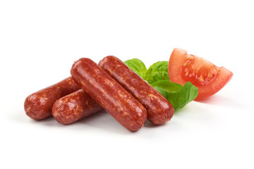 Salami smoked sausages with herbs and tomatoes isolated on white background