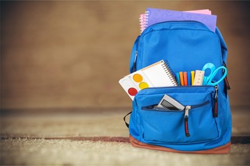 School bag on wooden background.