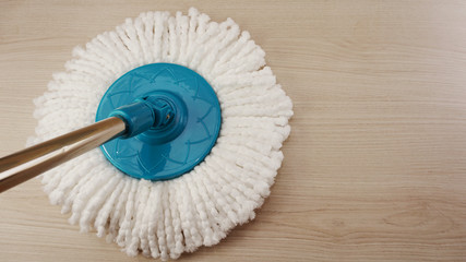 spinning mop with white microfiber on the floor