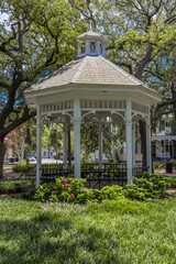 Fototapeta na wymiar JUNE 28, 2017 - SAVANNAH GEORGIA - Historic Savannah Georgia in early summer features a white gazebo in one of many town parks
