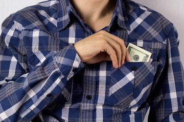 young man with dollar banknotes in pocket