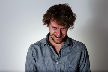 Creepy expression from a young, crazy male