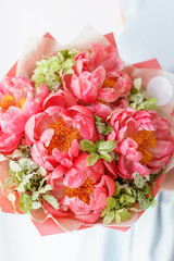 Lovely flowers in glass vase. Beautiful bouquet of peonies sort of coral charm. Floral composition, scene, daylight. Wallpaper