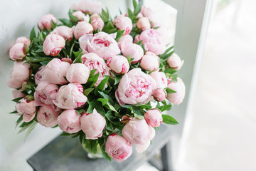 Lovely flowers in glass vase. Beautiful bouquet of pink peonies . Floral composition, scene, daylight. Wallpaper