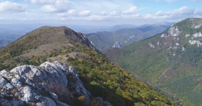 Flight over of man standing on the edge of mountain - Transylvania
