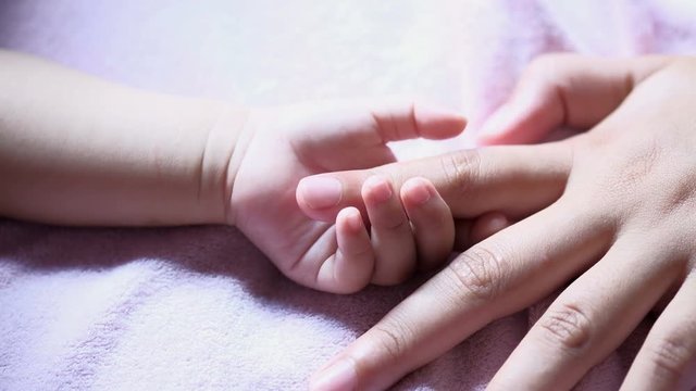 Little hand of newborn baby.  care and birth concept.