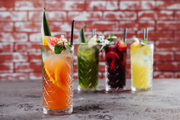 Four fruit cocktails on table.