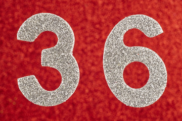 Number thirty-six silver color over a red background. Anniversary