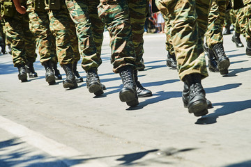 Soldiers dressed in camouflage uniform in an army parade.