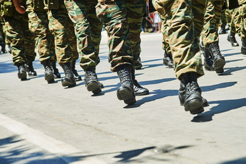 Soldiers dressed in camouflage uniform in an army parade. © markara