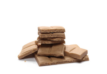 White nougat chocolate bar pieces with hazelnuts isolated on white background