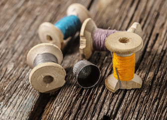 colored threads and thimble