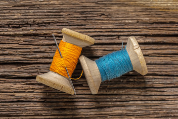 colored threads and needle