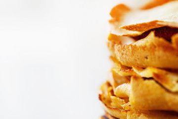 A stack of pancakes with white copy space. Closeup, selective focus