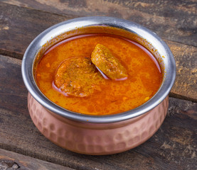 Indian Traditional Cuisine Gatta Curry Also Called Gatte ki Sabji or Besan Gatta is a Rajasthan Famous Food on Wooden Background