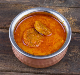 Indian Traditional Cuisine Gatta Curry Also Called Gatte ki Sabji or Besan Gatta is a Rajasthan Famous Food on Wooden Background