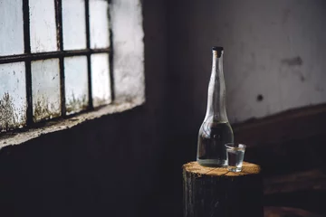 Printed kitchen splashbacks Bar Strong alcohol drink in bottle with shot glass