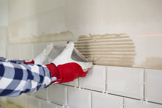 Process Of Tiling The Tiles In The Kitchen. Home Improvement, Renovation Concept