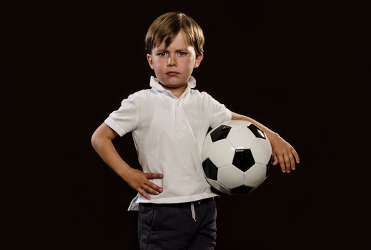 Young child holding a soccer ball