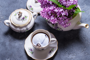 Porcelain tea set decorated with lilac, summer morning