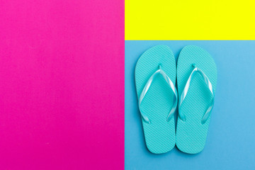 Female flip flops on a color block background