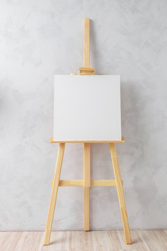 Wooden easel in the room