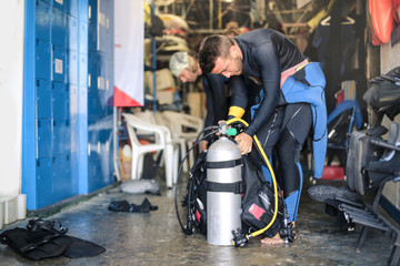 Scuba diver checking oxygen tank