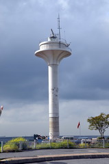 Radar tower against the sky with clouds