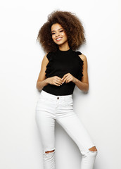 Portrait of young beautiful cute cheerful black girl smiling looking at camera over white background