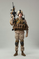 Soldier in camouflage holding rifle