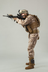 Soldier in camouflage holding rifle