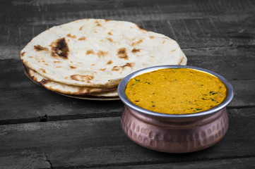 Indian Vegetarian Cuisine Dal Makhani Also Know as Dal Makhni or Daal Makhani is A Popular Dish From Punjab, Cooked With Black Lentil, Red Kidney Beans, Butter And Cream. on Vintage Wooden Background