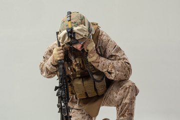Soldier in camouflage holding rifle