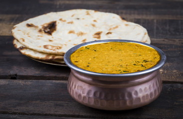 Indian Vegetarian Cuisine Dal Makhani Also Know as Dal Makhni or Daal Makhani is A Popular Dish From Punjab, Cooked With Black Lentil, Red Kidney Beans, Butter And Cream. on Vintage Wooden Background