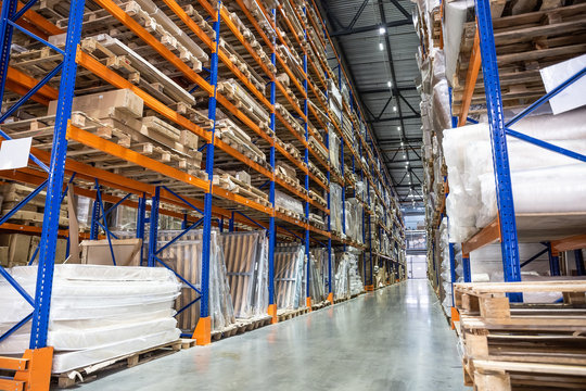 Logistics equipment, Large hangar warehouse with lots shelves or racks with pallets of goods. Industrial shipping and cargo delivery distribution