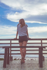 Female looking at the distant ocean / sea view.