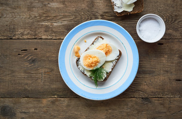Sandwich with butter and boiled eggs on a plate       