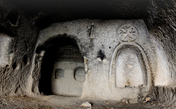 Interior of ancient cave christian temple with image of cross cut on the wall, Soganli ,Cappadocia, Turkey