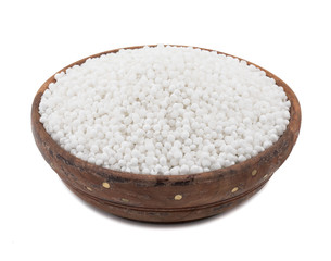 Fototapeta na wymiar White Sago Pearls in Wooden Bowl Also Know as Sabudana, Tapioca Pearl or Sago Seeds isolated on White Background