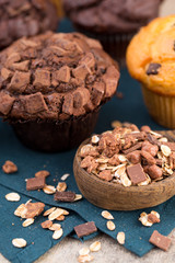 Homemade muffins with chocolate, vintage background.
